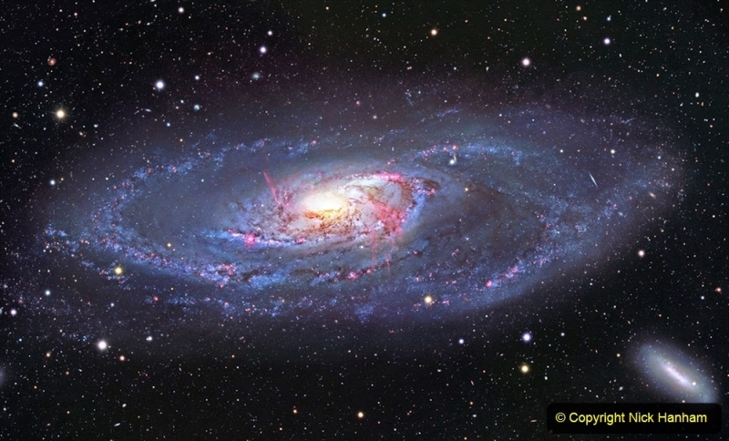 This image of the spiral galaxy Messier 106, or NGC 4258, was taken with the Nicholas U. Mayall 4-meter Telescope at Kitt Peak National Observatory, a Program of NSFâ€™s NOIRLab. A popular target for amateur astronomers, Messier 106 can also be spotted with a small telescope in the constellation Canes Venatici. This view captures the entire galaxy, detailing the glowing spiral arms, wisps of gas, and dust lanes at the center of Messier 106 as well as the leisurely twisting bands of stars at the galaxyâ€™s outer edges. Two dwarf galaxies also appear in the image: NGC 4248 in the lower right and UGC 7358 in the lower left.