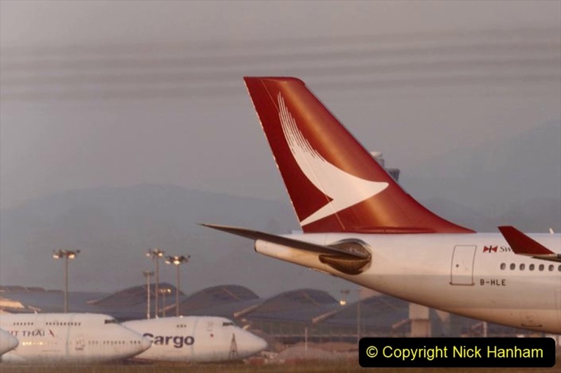 The tail fin of an Airbus SE A330-342 aircraft operated by Cathay Dragon, a unit of Cathay Pacific Airways Ltd., right, is seen at Hong Kong International Airport at dusk in Hong Kong, China, on Saturday, March 11, 2018. Cathay Pacific is expected to report a full-year net loss of HK$2.7 billion ($345 million) for 2017, after a first-half deficit of HK$2.05 billion, according to the median estimate in a Bloomberg News survey of five analysts. Photographer: Anthony Kwan/Bloomberg