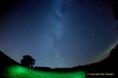 Perseid Meteors fall to Earth as the galaxy continues to spin.

A conbination of a 45 minute long exposure (with a little light-painting), followed immediately by a 30 second exposure for the static stars (so you can see which ones made the trails) followed by three more shots of the Persid shooting stars falling. An amazing show, which I got out of bed at 1.30am to go out and capture. 

Photography, astronomy and train-spotting.... geeking it up large in the post-production.