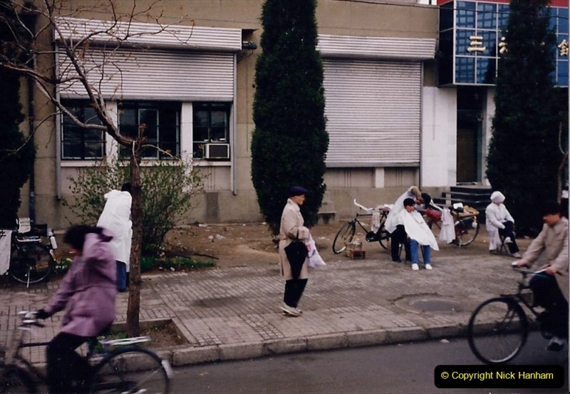 China 1993 April. (119) Beijing. On street barber.119