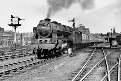 UNITED KINGDOM - MAY 16:  British Railways Royal Scot class 4-6-0 steam locomotive No 46145 'Duke of Wellington's Regiment' leaving Leeds with the Thames-Clyde passenger express from London to Glasgow. Photographer Eric Treacy.  (Photo by SSPL/Getty Images)