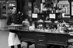 UNITED KINGDOM - NOVEMBER 15:  Buffet refreshment trolley with attendant, Derby station, Derbyshire, 23 February 1908. Buffet refreshment trolley with attendant, Derby station, Derbyshire, 23 February 1908. Refreshments on offer include fruit, Bovril, hot milk and Bolinger champagne. Midland Railway official photograph.  (Photo by Science & Society Picture Library/SSPL/Getty Images)