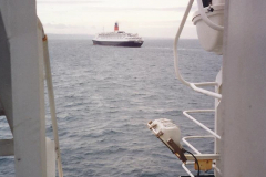 1994 France. (157) As we leave Cherbourg we pass the QE2 on a Normandy Landings Cruise. 162