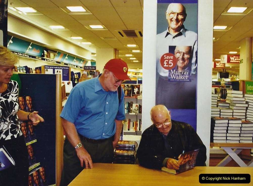 2002-Miscellaneous.-212-Murray-Walker-signing-his-book-for-your-Host.-212